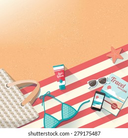 Fashion beach accessories on the sand, towel, swimming costume, bag, mobile phone, magazine and sun lotion, travel and holidays concept with copy space