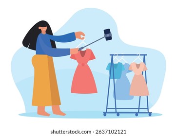 Fashion blogger presenting clothes using selfie stick and smartphone, recording video for social media, online store, live streaming, advertising new collection