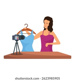 Fashion blogger recording a video blog presenting a dress on a hanger
