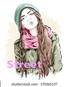 Fashion girl wearing modern knit cap and jacket. Street style clothes. Sketch woman.