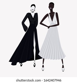 Fashion girls of different races in fashionable evening dresses stand nearby posing isolated on a white background. Black and white dress. Black and white fashion model.