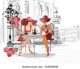 Fashion girls in the street cafe.