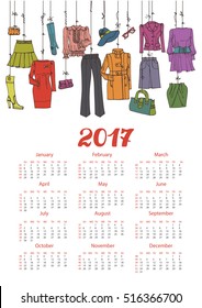 Fashion illustration.Calendar 2017 new year.Vector hand drawn  fashionable women  clothes and accessories hanging on rope.Background, design template.Autumn,spring wear