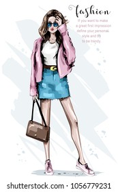 Fashion look. Beautiful young woman with bag. Stylish woman in sunglasses. Sketch. Vector illustration.