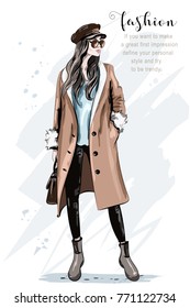 Fashion model posing. Stylish beautiful woman in coat and cap. Hand drawn fashion woman. Sketch. Vector illustration.