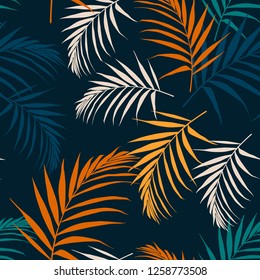 Fashion night style jungle pattern  seamless background. Bright colors palm leaves isolated on dark blue background.