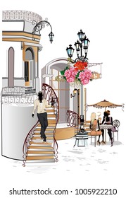 Fashion people in the street cafe. Street cafe with flowers in the old city. Waiters serve the tables. 