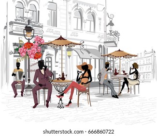 Fashion people in the street cafe. Street cafe with flowers in the old city. Waiters serve the tables.