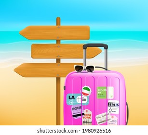 Fashion pink travel bag on a beach