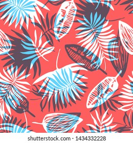 Fashion seamless pattern with overlap mess of bright blue and white tropical leaves on red background. Trendy exotic plants texture for textile, wrapping paper, surface, wallpaper, background