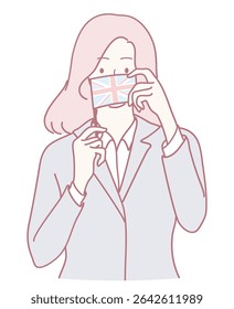 A fashionable businesswoman skillfully adjusts her Union Jack patterned face mask, reflecting her cultural identity