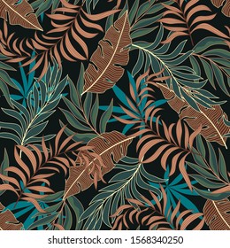 Fashionable seamless tropical pattern with bright brown and green plants and leaves on dark background. 
Tropic leaves in bright colors. 
Colorful stylish floral.