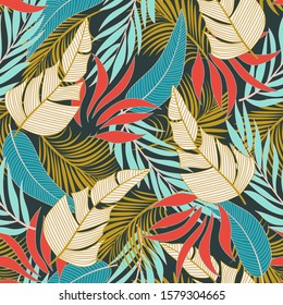 Fashionable seamless tropical pattern with bright blue and red flowers and plants and leaves on green background. Tropic leaves in bright colors. Modern abstract design for fabric, paper.