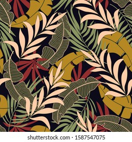 Fashionable seamless tropical pattern with bright yellow and red plants and leaves on black background. Modern abstract design for fabric, paper, interior decor. 
Summer colorful hawaiian.