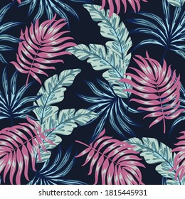 Fashionable seamless tropical pattern with bright plants and leaves on a dark blue background. Vintage pattern. Jungle leaf seamless vector floral pattern background. Beautiful exotic plants. 