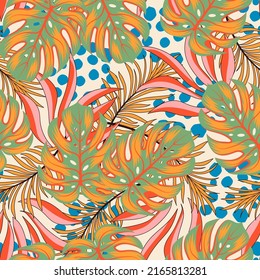 Fashionable seamless tropical pattern with bright plants and leaves on a pastel background. Seamless exotic pattern with tropical plants. Tropic leaves in bright colors.