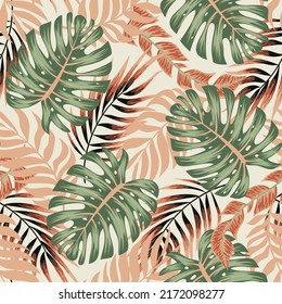 Fashionable seamless tropical pattern with bright plants and leaves on a beige background. Summer colorful hawaiian seamless pattern with tropical plants. Tropic leaves in bright colors.