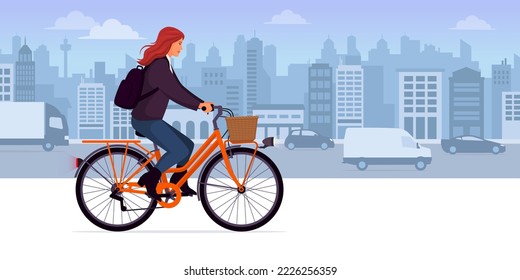 Fashionable woman riding a bicycle in the city street, transport and lifestyle concept