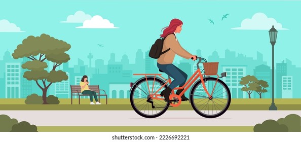 Fashionable woman riding a bicycle at the park, transport and lifestyle concept