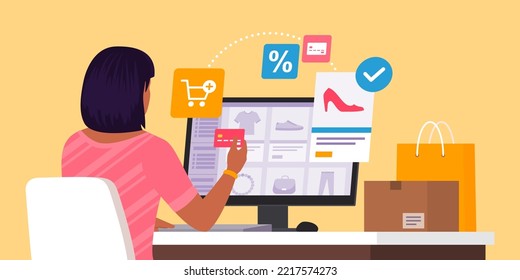 Fashionable woman sitting at desk and doing online shopping with her computer, she is ordering a pair of shoes and paying with a credit card: sale, delivery and technology concept