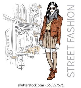 Fashionably dressed girl on the background of a city street. Vector illustration for greeting card, poster, or print on clothes. Fashion & Style. Beautiful girl.