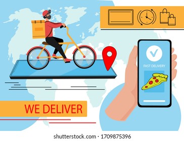 Fast delivery man in a protective mask rides a bicycle. Hand holds smartphone. Online shopping. Concept of quarantine sitting at home