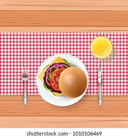 Fast food with fork and knife on wooden table