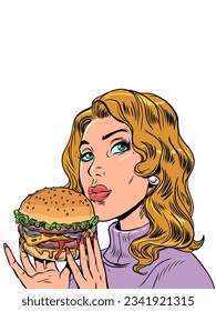 Fast food restaurant prepares burgers. The girl is holding a burger with her hands.