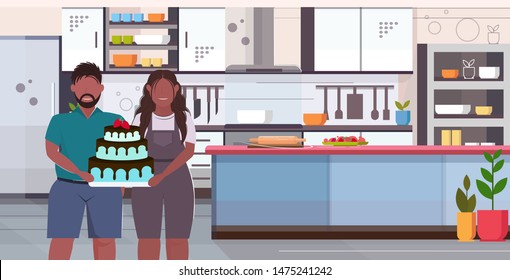 fat obese coupe holding big chocolate homemade cake sweet delicious overweight man woman celebrating holiday unhealthy nutrition obesity concept modern kitchen interior portrait horizontal