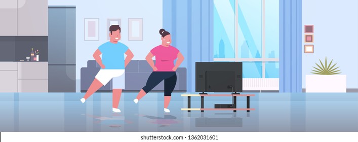 Fat Obese Couple Exercising During Tv Show Overweight Man Woman Training While Watching Fitness Program Home Workout Weight Loss Concept Living Room Interior Full Length Horizontal