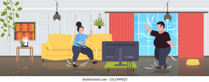 fat obese couple exercising during tv show overweight man woman training while watching fitness program home workout weight loss concept modern living room interior full length horizontal