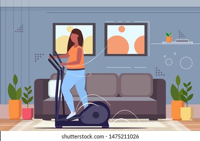 fat obese woman working on elliptical trainer overweight african american girl doing spinning exercises cardio training workout weight loss concept living room interior full length horizontal