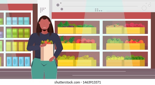 fat overweight man holding groceries shopping bag diet weight loss concept obese guy with vegetables and fruits organic food modern grocery shop interior portrait flat horizontal