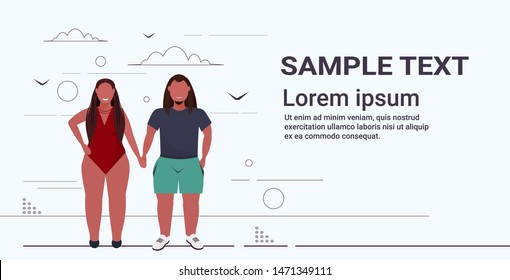 fat overweight woman in swimsuit holding hands with obese man plus size african american couple standing together unhealthy lifestyle obesity concept full length flat horizontal copy space