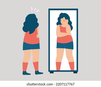 Fat woman looks on her reflection in the mirror in a sad way. Girl sees herself and looks upset. Low self esteem, Unhealthy diet, weight control, Mental Disorder, body Dysmorphic Disorder concept.