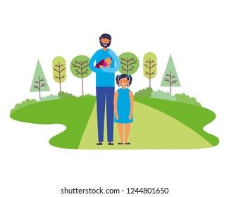 father carrying baby and daughter in the park
