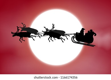 Father Christmas riding his sleigh with reindeer in front of a full moon on red sky background.