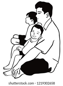 A father and his children are sat together on the floor.