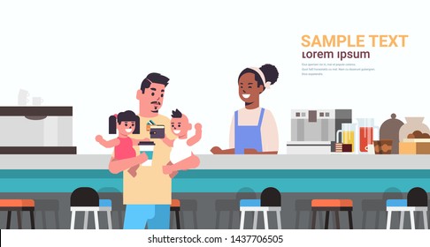 father with little son and daughter at cafe counter paying for coffee fatherhood concept happy family having fun modern cafeteria interior flat portrait horizontal