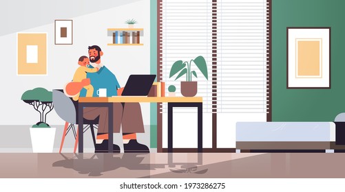 father sitting at workplace with little son fatherhood parenting concept dad spending time with his kid at home