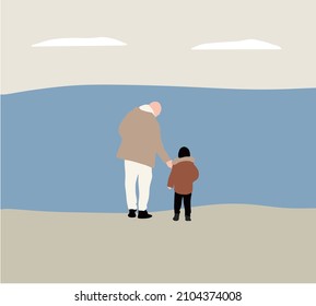 Father and son holding hands while walking on sand at beach. Fatherhood Family Concept
