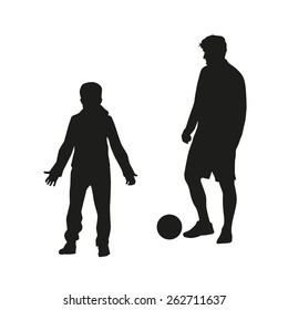 Father and son playing football. Vector silhouette