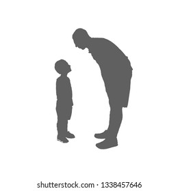 Father and son silhouette. The man leaned over the boy and looked at each other.