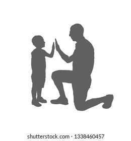 Father and son silhouette. A man stands on one knee in front of the boy and clap his hands.
