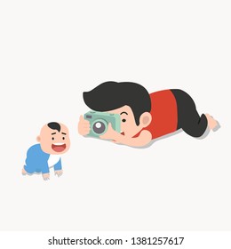 father  takes pictures of a child