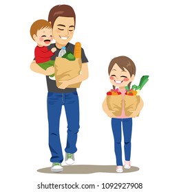 Father walking with kids holding baby boy and paper grocery bag full of vegetables water bread and helper daughter