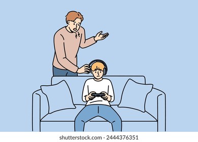 Father yells at naughty child who plays video games and refuses to do homework or comply with parents demands. Naughty guy resists upbringing, wanting to become cyber athlete or professional gamer