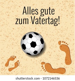 Fathers Day. Concept of holiday. On the beach a soccer ball, footprints of father and child. German greeting - Alles gute zum Vatertag - in English means - Happy Fathers Day