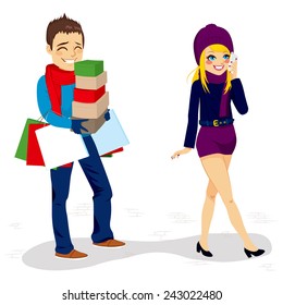 Fatigued boyfriend walking carrying shopping bags and boxes of his girlfriend while she is talking by phone