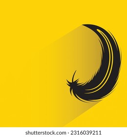 feather with shadow on yellow background